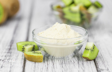 Bowl with fresh made Kiwi powder (selective focus)