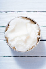 macadamia nut butter cream, skin care product sample on white wooden table