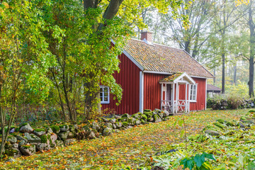 Old wooden cottage by a path in the countryside