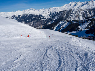 France, february 2019: Skiers on a piste at Courchevel ski resort, French Alps