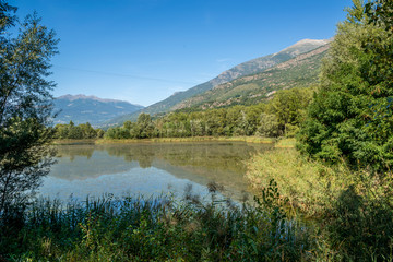 Fototapeta na wymiar mountain panorama with blue lake in the last days of summer