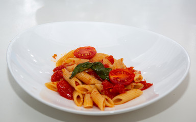 Italian pasta with tomato sauce and basil