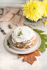 savoury pancakes with sour cream, autumn scene, light background, leaves, golden daisy flower