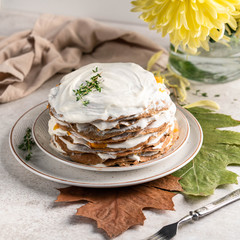 savoury pancakes with sour cream, autumn scene, light background, leaves, golden daisy flower