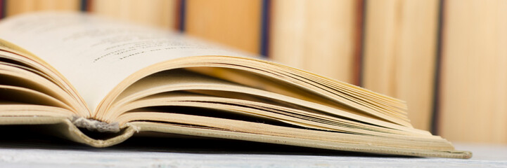 Open book, hardback books on wooden table. Back to school. Copy space