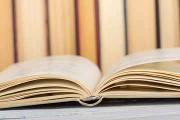 Open book, hardback books on wooden table. Back to school. Copy space