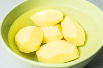 Peeled new potatoes in deep dish with water to remove nitrites.