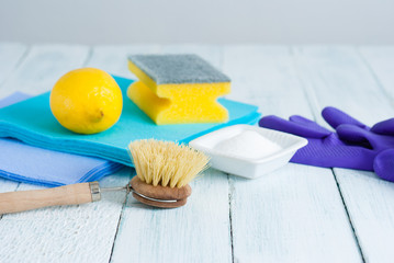 dishwashing tools and citric acid, lemon on white wooden