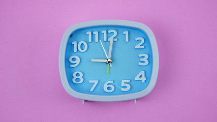 Blue Alarm clock face beginning of time 09.00 on pink background, Copy space for your text, Time concept..
