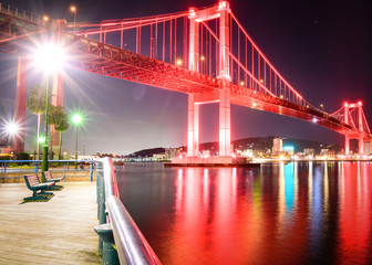 Wakato bridge in Kitakyushu, Fukuoka, Japan at night color red landscape long exposure photo. 