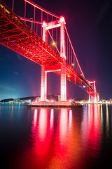 Wakato bridge in Kitakyushu, Fukuoka, Japan at night color red landscape long exposure photo. 