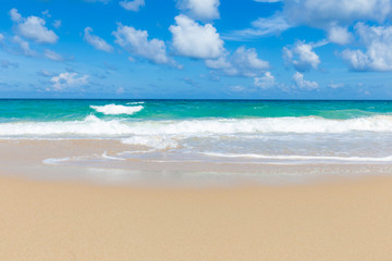 Sea wave on summer white beach with cloud sky