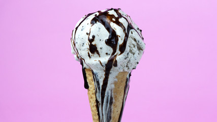 Cookies & Cream ice cream scoop in waffle cone on pink background, Closeup Front view Food concept.. - Powered by Adobe