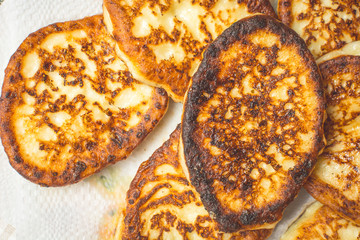 Curd cheesecakes on white napkin to absorb excess oil.