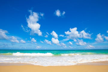 Sea wave on summer white beach with cloud sky