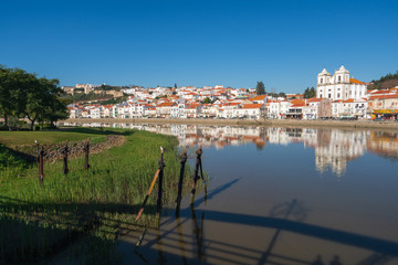 Fototapeta premium View of Alcacer do Sal cityscape from the other side of the Sado river