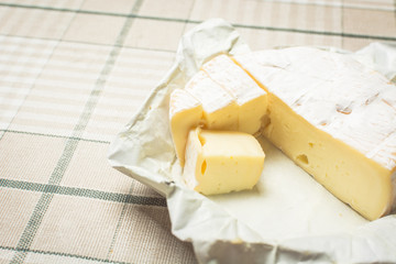 Yellow cheese on the kitchen table.