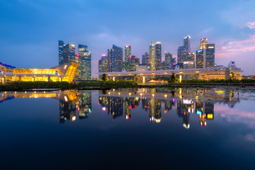 Fototapeta na wymiar Singapore, Singapore - June 28, 2019: Singapore business district skyline at twilight