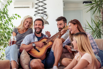 Group of friends have fun with guitar