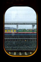 View from high speed train window in motion of countryside and small station