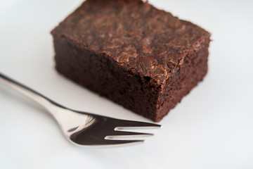 Brownie chocolate cake with fork closeup