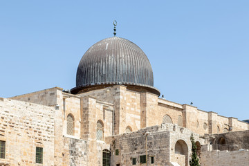 Fototapeta premium Part of the wall of the temple mountain and the dome of the Al Aqsa Mosque near the Dung Gate in the Old City in Jerusalem, Israel