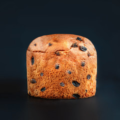 Christmas cake panettone. Delicious  Christmas cake decorated with fir tree branch on black background, copyspace