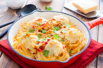 Tagliatelle pasta with meat balls and sauce in a pan, horizontal