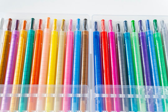 multicolored wax pencils in a box on a white background