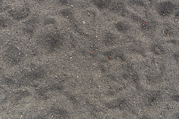 Black rough textured sandpaper background, close up