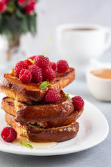 French toasts, French toasts made of sliced brioche with fresh raspberries, honey and mint. Delicious breakfast or dessert