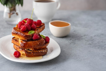 French toasts, French toasts made of sliced brioche with fresh raspberries, honey and mint. Delicious breakfast or dessert