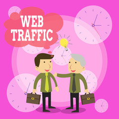 Conceptual hand writing showing Web Traffic. Concept meaning Amount of data sent and received by visitors to a website Businessmen Colleagues with Brief Case Sharing Idea Solution