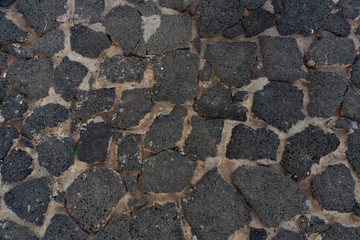Part of the pavement lined with uneven lava plates