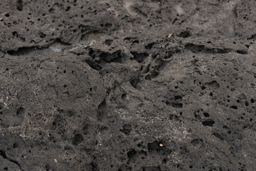 Amazing frozen lava pattern. Dark grey black slate background or texture.