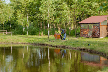 Fisherman catches of salmon fly fishing in the lake.