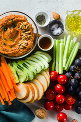  dip or spread of roasted red pepper and nuts. healthy vegan food for celebration or party . shot from above. copy space