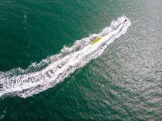 Aerial view of jet ski speeding on sea water surface, Holland