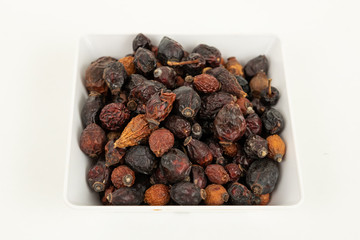 dry berry rose hips on white