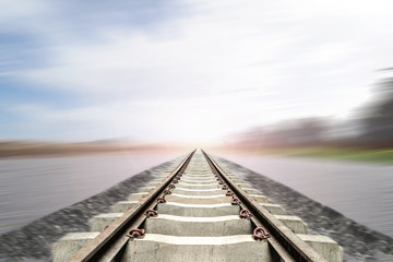 Train track with motion blur blue sky background. Feel like train is going to destination and finish to goal.