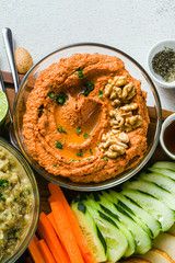  dip or spread of roasted red pepper and nuts. healthy vegan food for celebration or party . shot from above. copy space