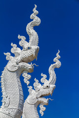 Fototapeta na wymiar Naga statue on blue color background.