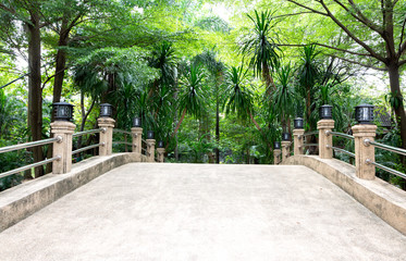 A white concrete bridge in a peaceful and beautiful garden.