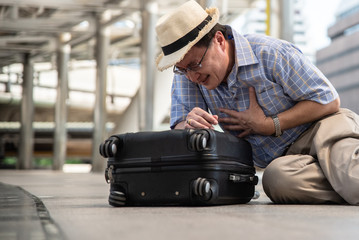 Low Section Of Man With Chest Pain Sitting On Footpath