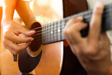 Close up of man hand playing acoustic guitar.