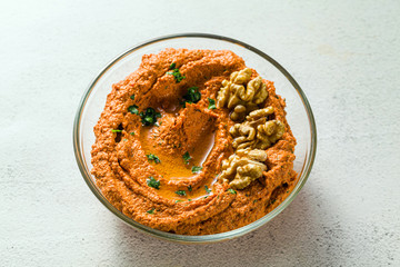  dip or spread of roasted red pepper and nuts. healthy vegan food for celebration or party . shot from above. copy space