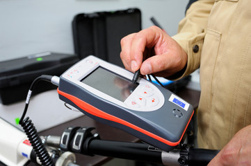 New radiation detectors testing. Dosimetrist adjusting a portable gamma radiation dosimeter 