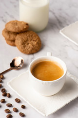 cup of tea and cookies on marble table