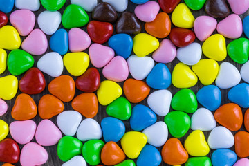 Background in the form of small sweets in the shape of a heart