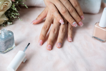 Obraz na płótnie Canvas Beautiful manicure nails paint with glitter and varnish in nail salon